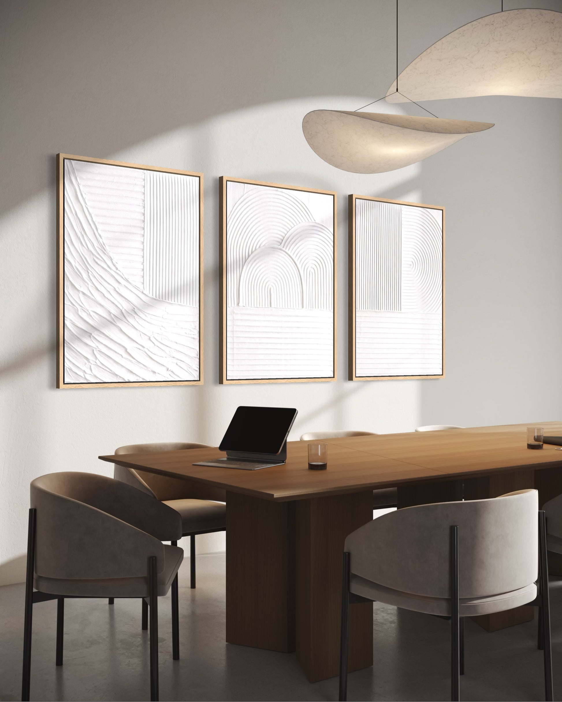 Modern office setting with a wooden desk, chairs, and abstract wall art.