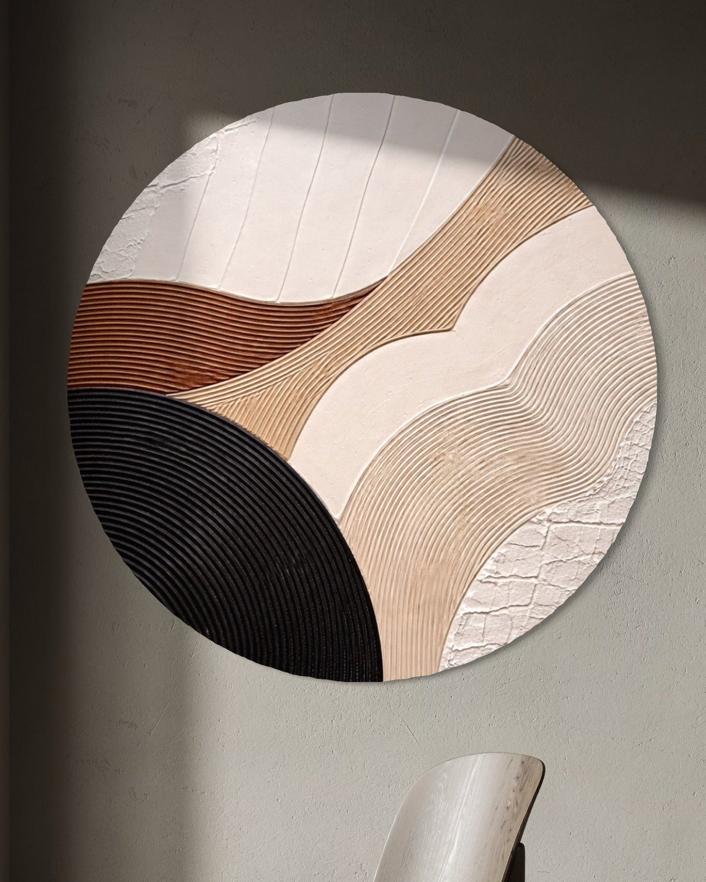 Round wall art piece with a modern chair in a minimalistic room.