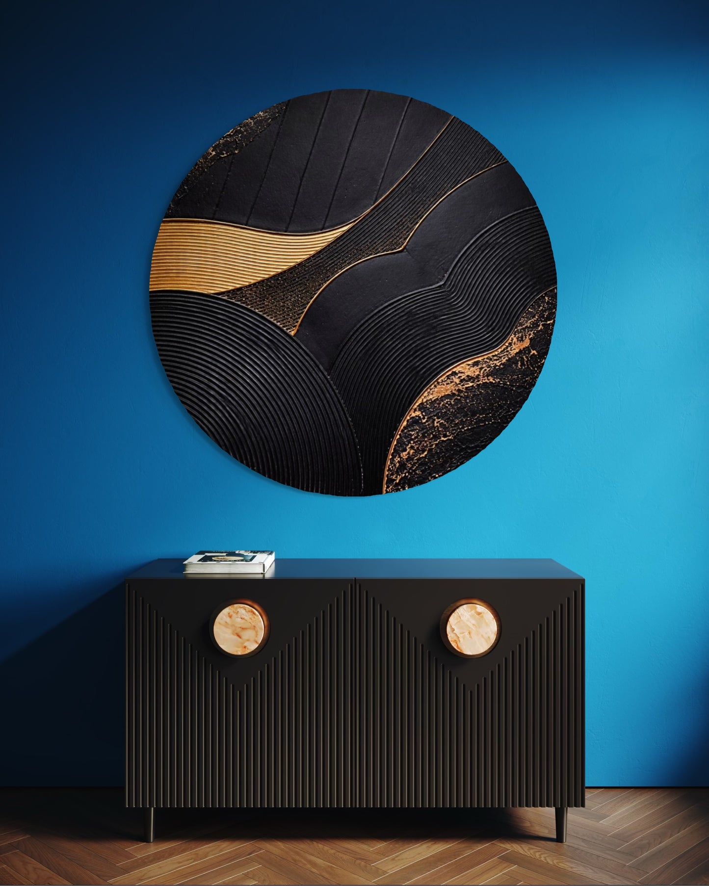 Round decorative wall piece with gold accents on a blue wall above a black console table.