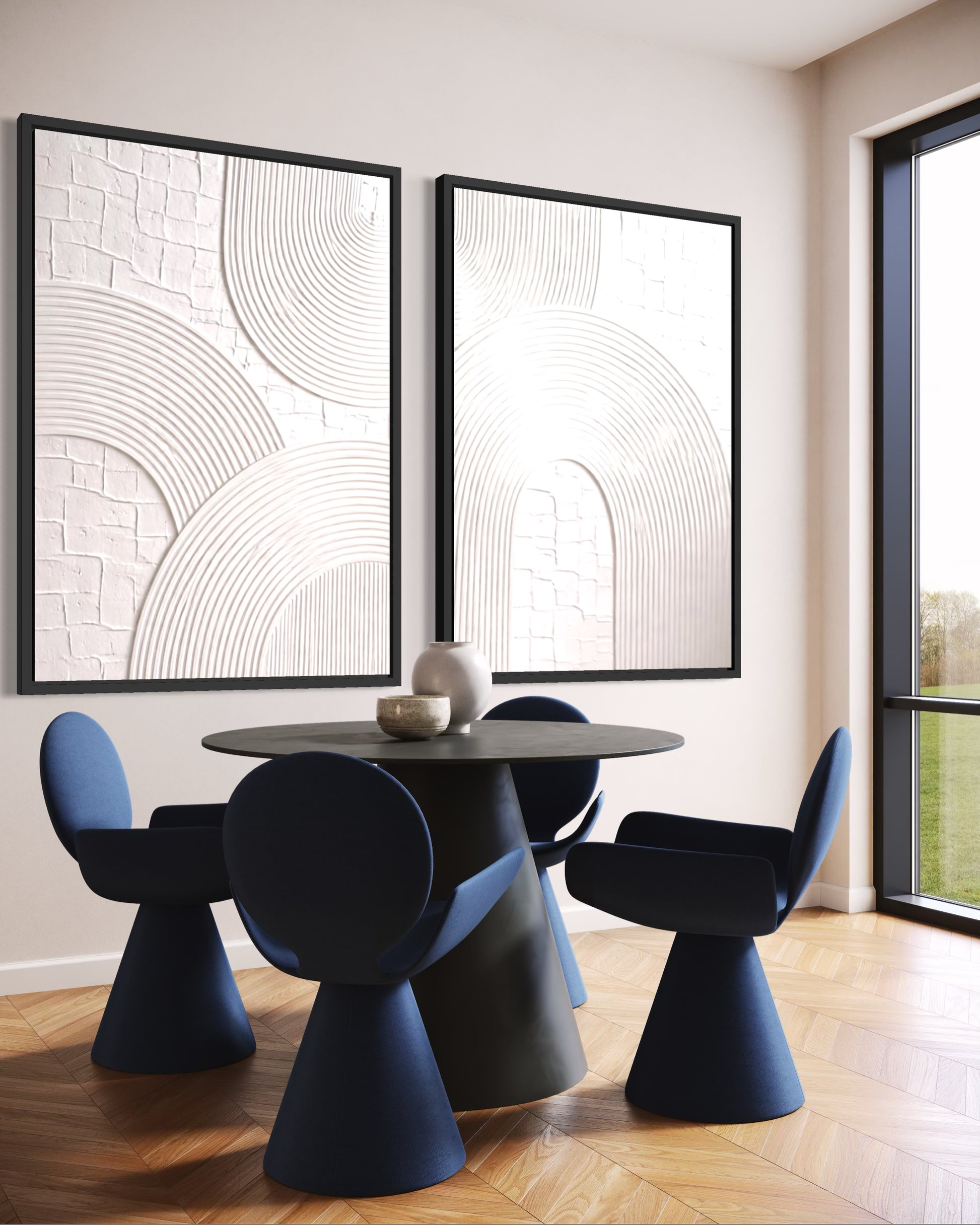 Modern dining room with black table and blue chairs, framed abstract art on the wall.