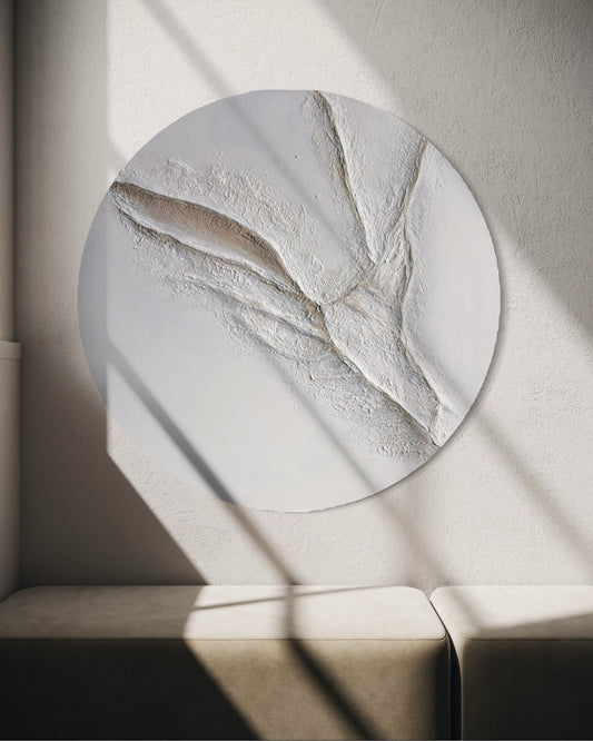Round decorative wall art with textured design on a neutral background