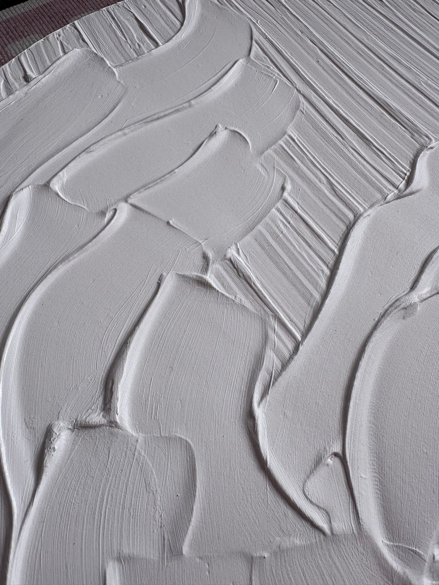 Close-up of white paint texture with brush strokes