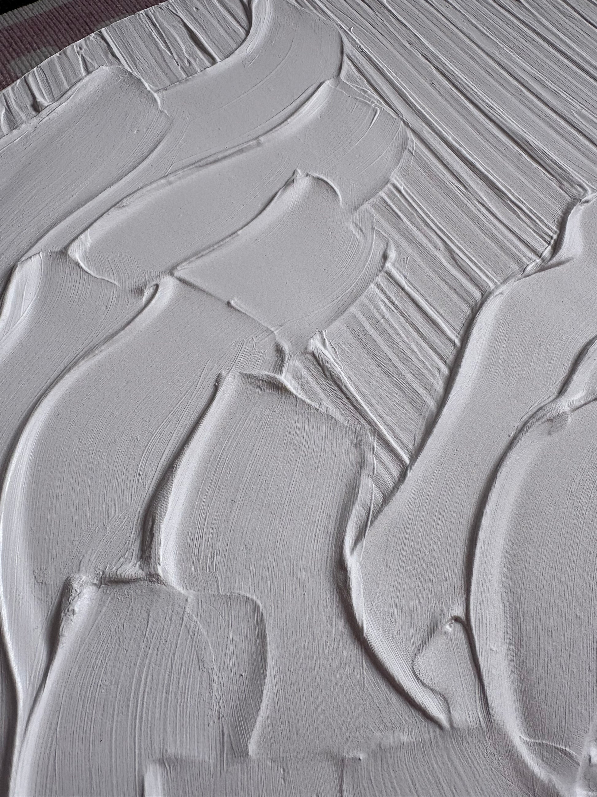 Close-up of white paint texture with brush strokes