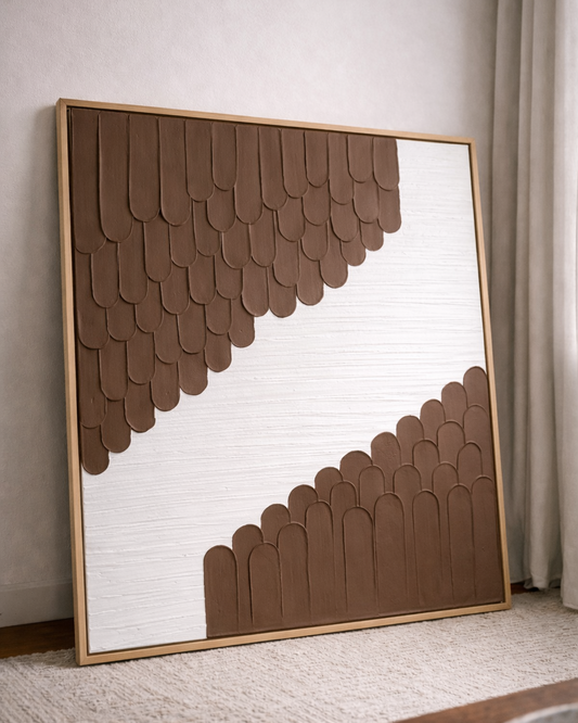 Decorative wall art with brown geometric pattern in a gold frame.