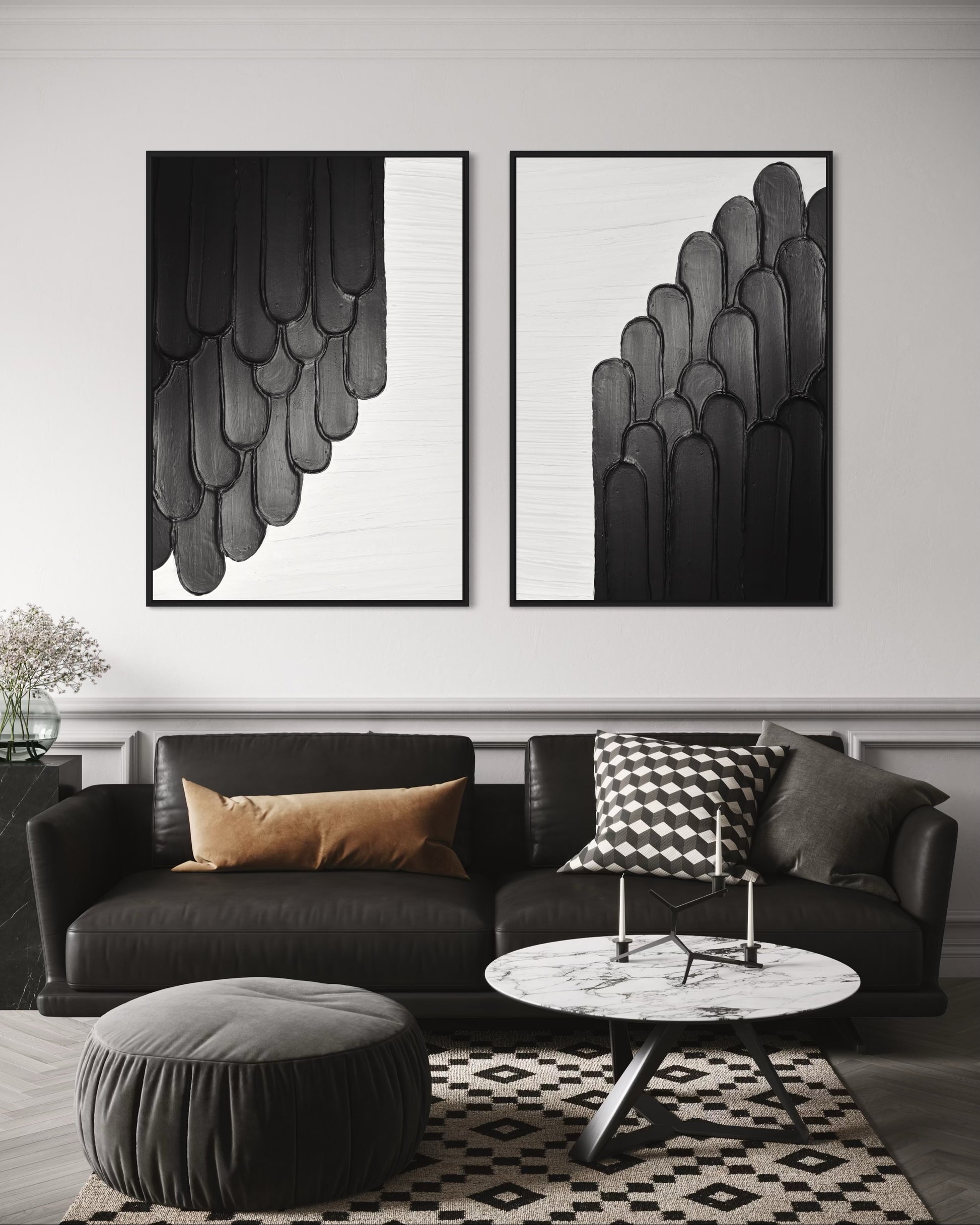 Modern living room with black sofa, round ottoman, and abstract modern textured art on the wall.