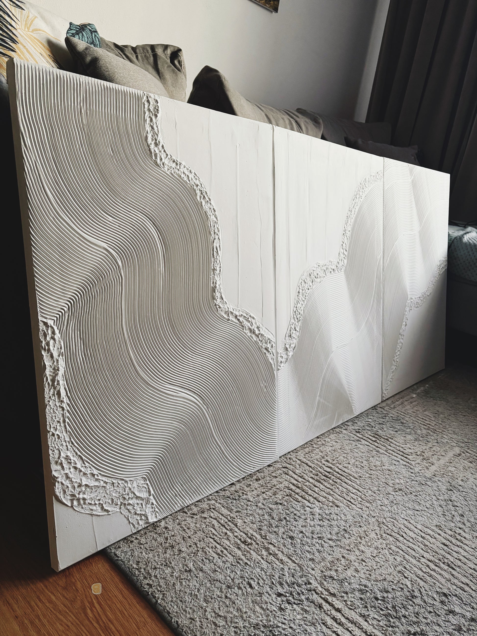 Decorative wall art with wavy texture and white color