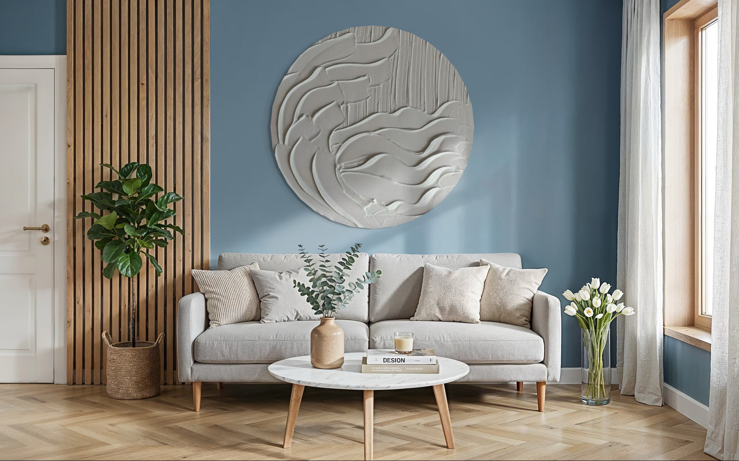 Modern living room with a gray sofa, round coffee table, and decorative wall art coastal