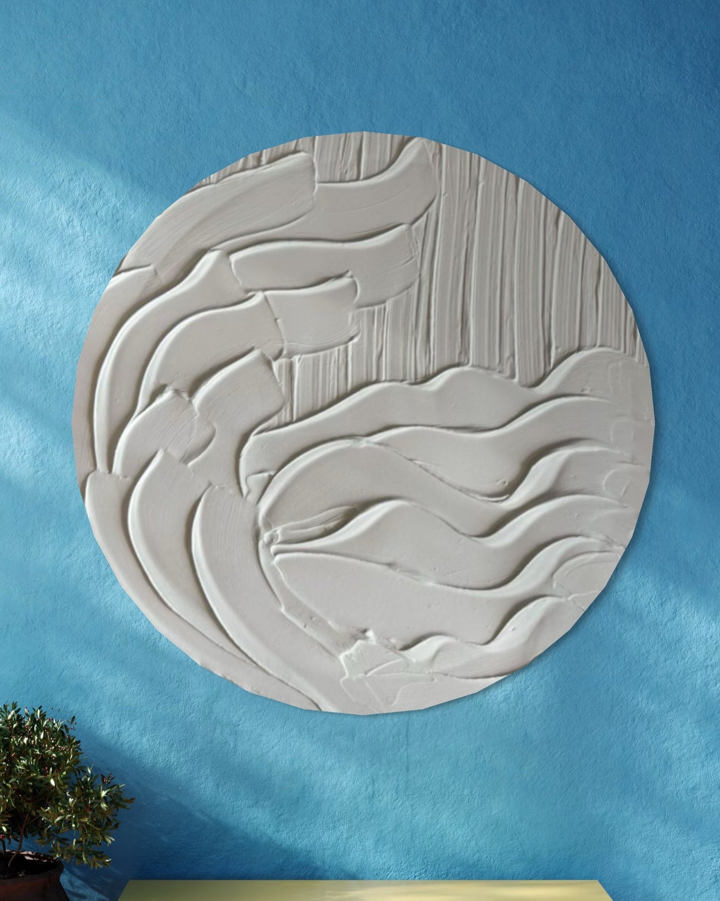 Decorative wall panel with wavy pattern on a blue wall, yellow bench, and potted plant.