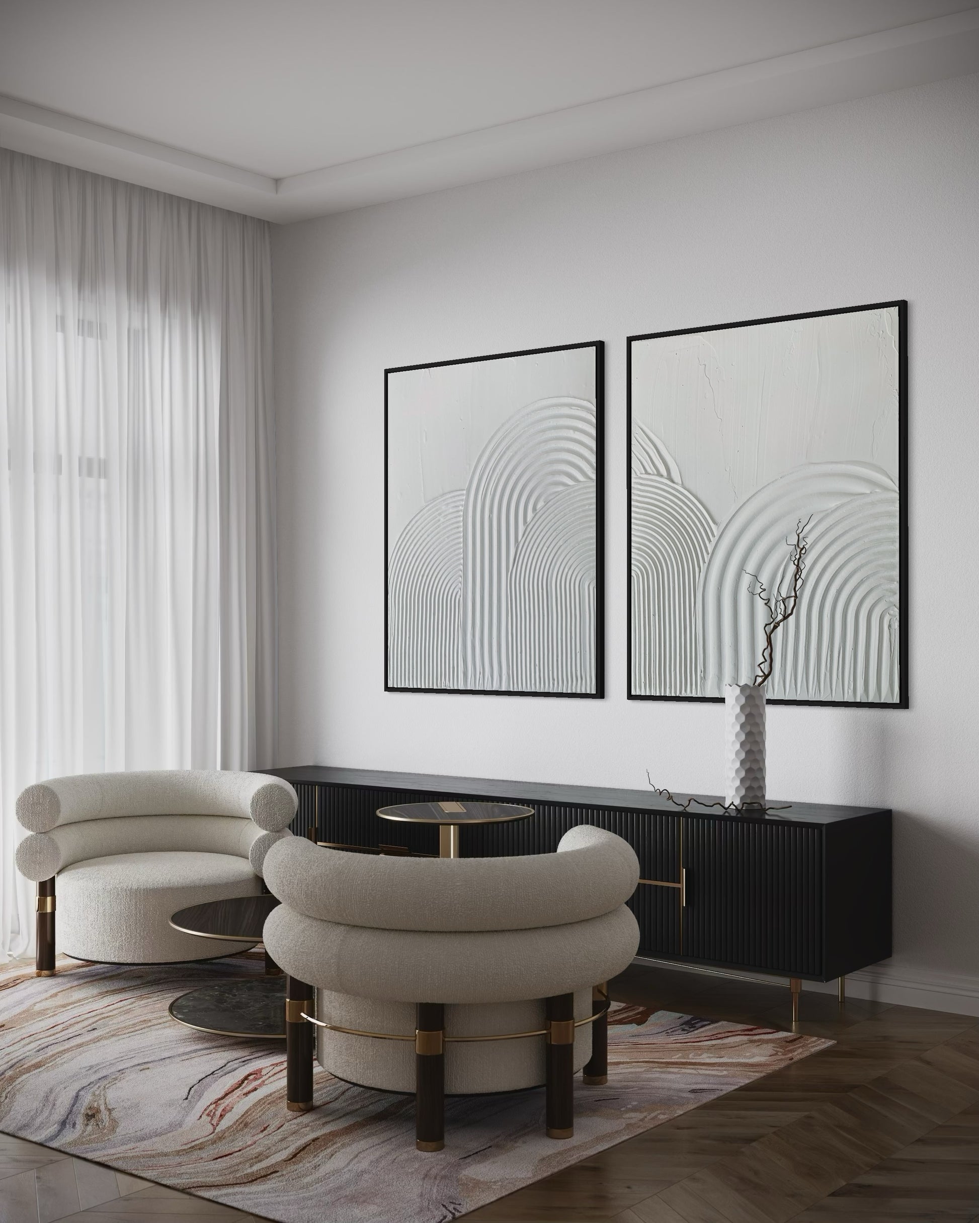 Modern living room with white chairs, a black console table, and abstract wall art.