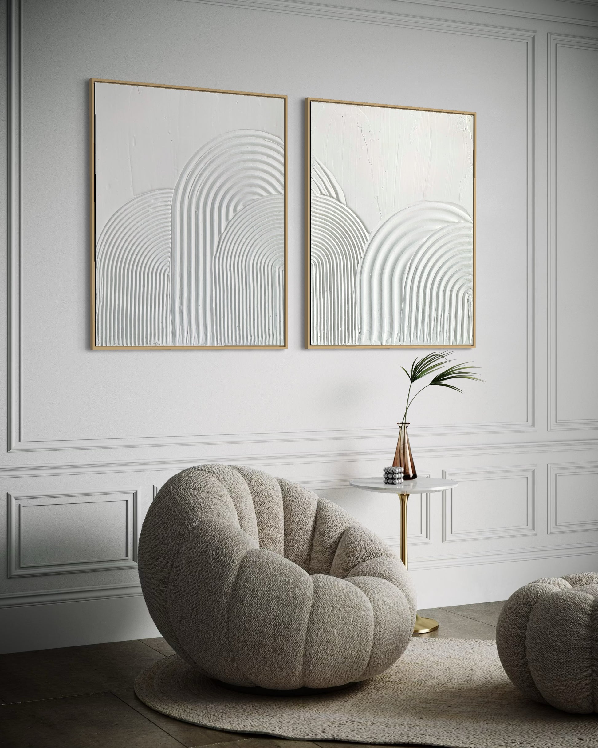 Modern interior with a round gray chair, small table, and abstract minimalist wall art set of 2 in white 