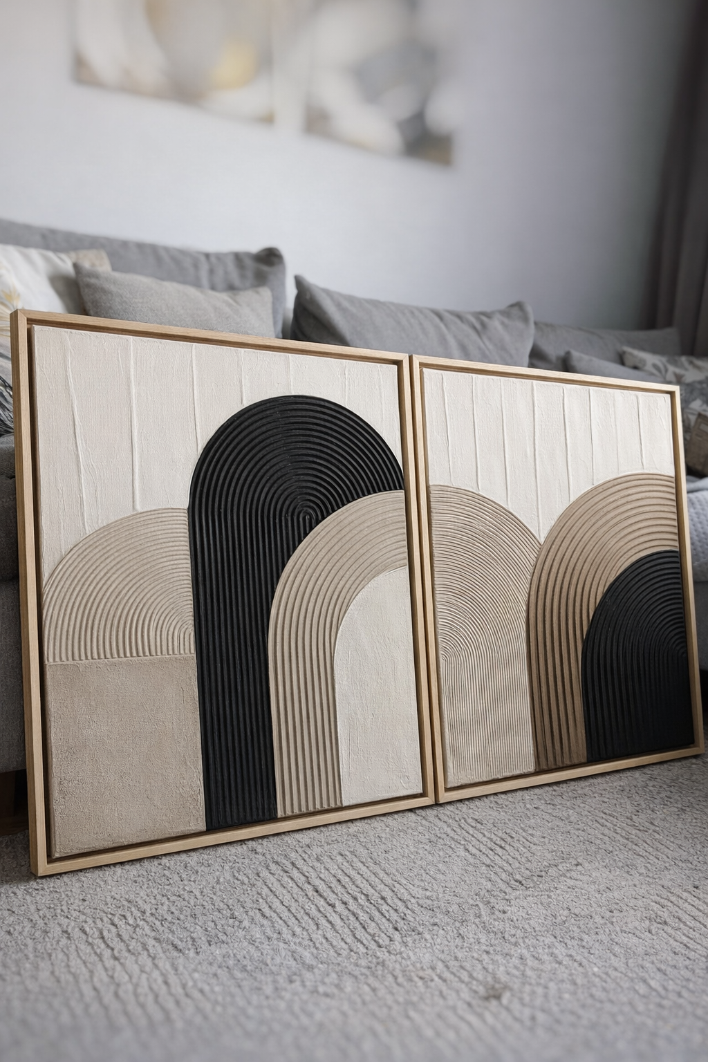 Two abstract wall art pieces with arch designs on a textured surface.