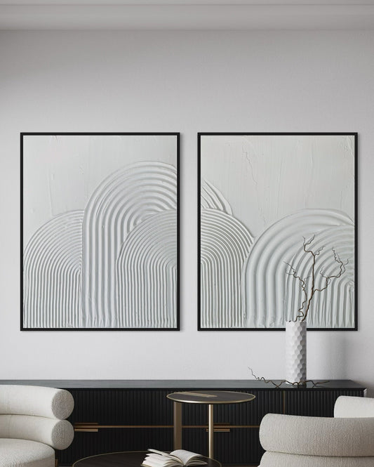 Modern living room with two white armchairs, a coffee table, and abstract wall art textured wall art in white
